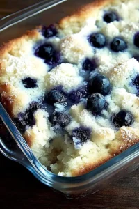 Buttermilch-Blauerbeeren-Kuchen auf einem Teller mit frischen Beeren