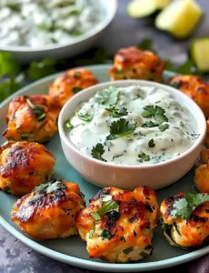 Hähnchen-Zucchini-Popcorn mit cremiger Koriander-Sauce auf einem Teller.